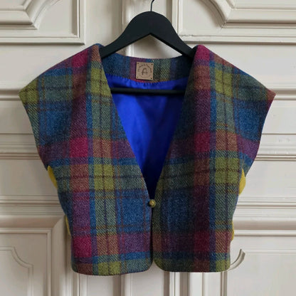 Boléro Odette en Harris Tweed et soie accroché sur un cintre à une double porte d'un appartement Napoléon III. On aperçoit l'étiquette de marque A la Mode d Temps Perdu ainsi que la doublure en soie bleue.