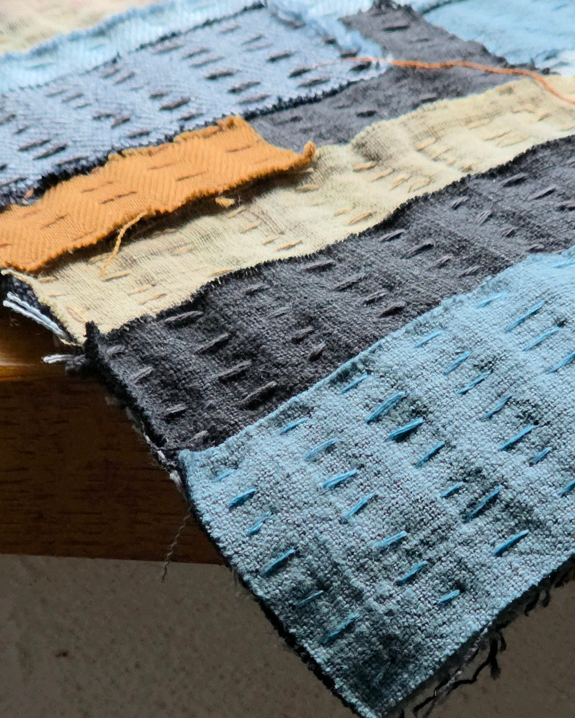 Détail des broderies et assemblages de denim, lin et coton de l’œuvre textile Échappée n°4