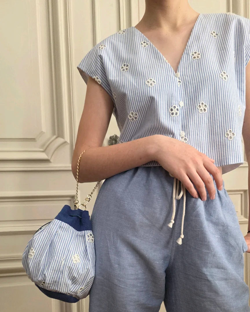 top Alizé en coton rayures bleu blanc avec broderie anglaise porté avec pantalon fluide et sac bourse assorti